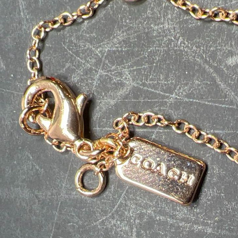 Coach Gold tone Faux Pearl Ring and Rhinestone Necklace